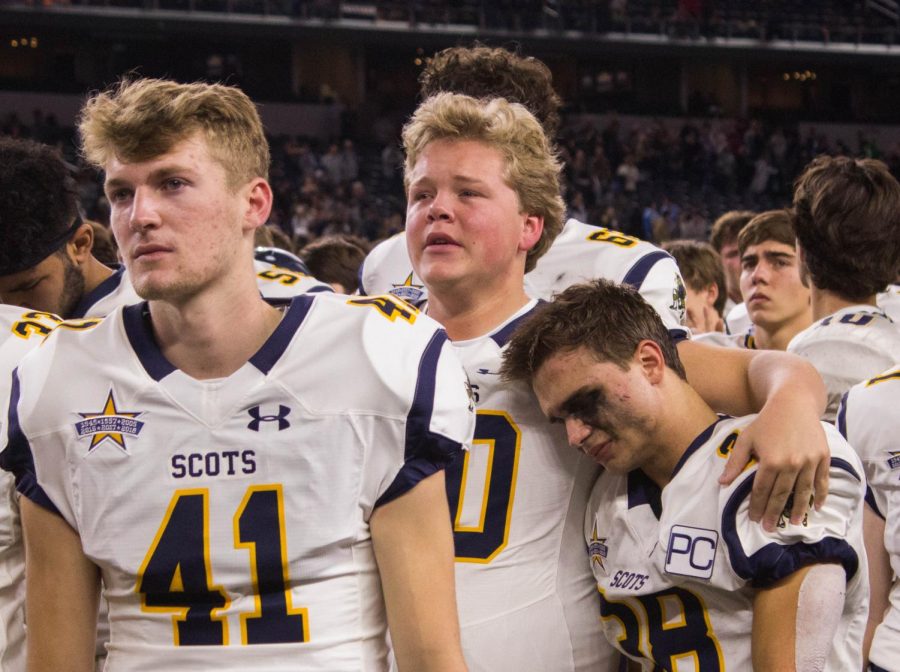 Senior Clint Conger comforts senior Hunter Heath after losing the game against Lone Star.