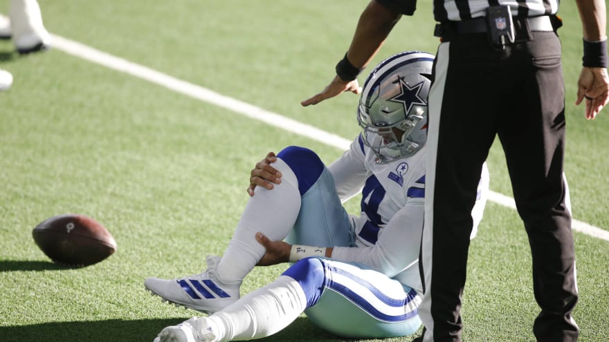 Prescott holds his right ankle after injuring it moments before. Prescott was transported to a local hospital immediately after this.