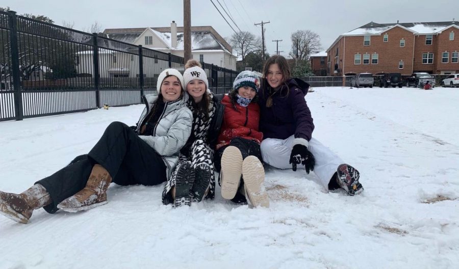 Seniors+Isabel+Applewhite%2C+Hilary+Hansford%2C+Sarah+Rogers+and+Katie+Arnold+sit+together+while+watching+their+friends+sled+behind+a+car.+Because+there+was+no+school+for+the+week%2C+the+students+made+the+best+of+it+and+spent+quality+time+with+friends.+We+took+the+time+to+get+together+and+spend+some+time+away+from+technology+and+school+and+had+some+old+fashioned+fun+in+the+snow%2C+Arnold+said.+
