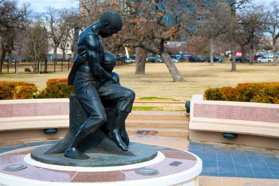 A statue depicting two Black former slaves embracing, one with a scarred back from whips, sits at the middle of the Freedmans Cemetery Memorial. Artist David Newton made the sculpture, titled Dream of Freedom, in 1990. 