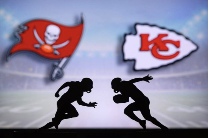 The silhouette of a Kansas City Chiefs player sprints towards a player from the Tampa Bay Buccaneers. The 2021 Super Bowl will have limited in-person attendance.