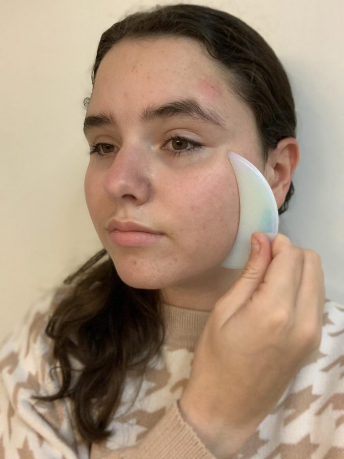 Freshman Isabella Navarro uses the Gua Sha. Navarro planned on trying the tool for a few days to see if results are in store. 