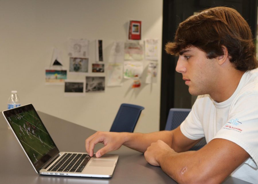 Senior Captain George Wright studies film before a varsity game. Film helped the players understand what they need to focus on each week. "Every Tuesday morning, one player will bring donuts and we will watch game film as a group," Wright said.