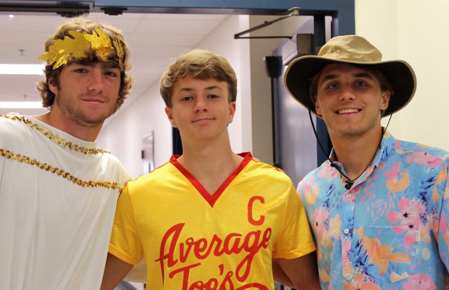 On character day Blake Bevans, William Sherwood and Luke Rossley pose for the camera. They dressed up as an ancient Greek man, a baseball player and a fisherman. Homecoming week is fun because we get to dress up, Bevans said.
