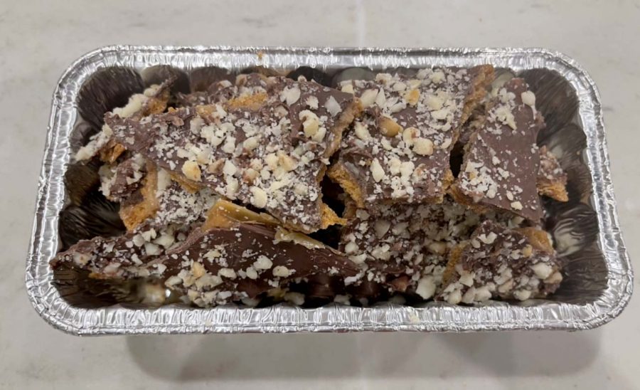 The final product of the Graham Cracker Toffee recipe. The dessert is made using graham crackers, chocolate chips and macadamia nuts.