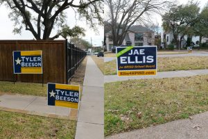 To signal their support for board of trustees candidates Tyler Beeson and Jae Ellis, residents install signs in their lawns. The two candidates are running against each other for Place Four on the board.