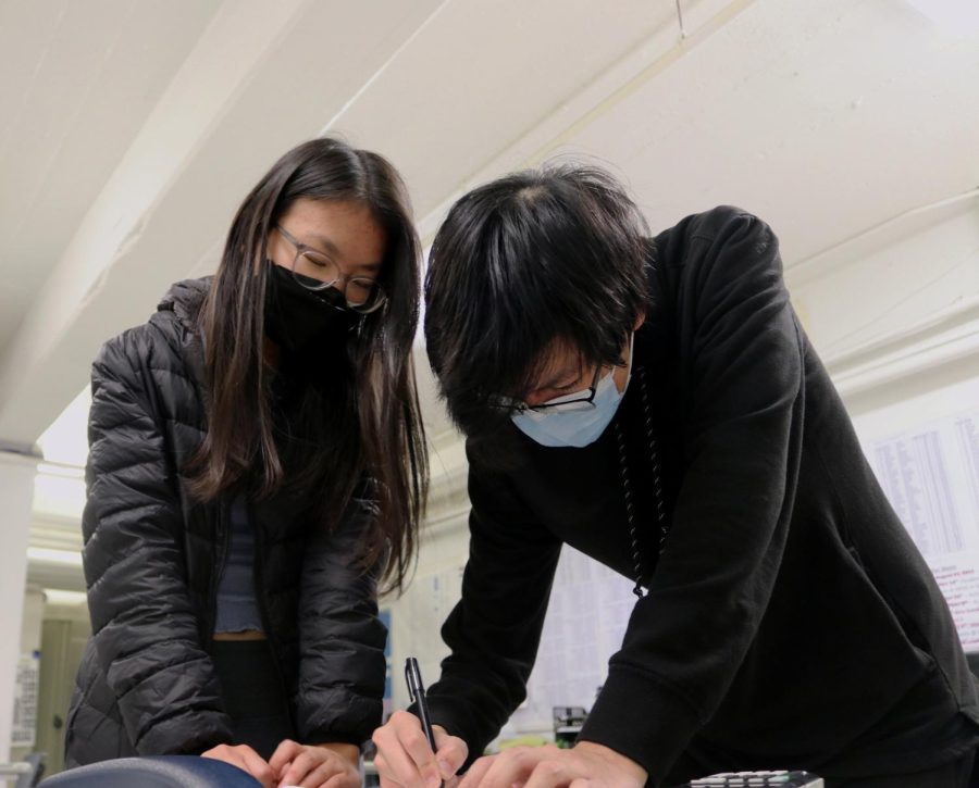 In preparation for the state championship, senior Jack Jiang and freshman Anna Qian study a packet of math problems. Because there was more pressure with this competition, the team studied more than they normally do. “Usually for the regular scrimmages, we go over data from [the packet] for an hour and then leave, but for state we do this for a whole week and focus on things such as studying,” Jiang said. 