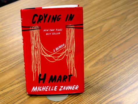 On the cover of “Crying in H Mart, noodles hang from two pairs of chopsticks. Food serves as a symbol of the Korean culture connecting the author, singer Michelle Zauner, and her late mother in the memoir that tells the story of how she adjusted to her mothers cancer diagnosis.