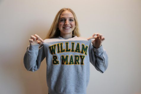 After being accepted into The College of William and Mary, senior Kate Hamilton poses in a school sweatshirt. Hamilton chose to go the traditional route and submit her test scores when applying. I chose to submit my test scores because I felt they reflected me well as a student and aided my applications, she said. 