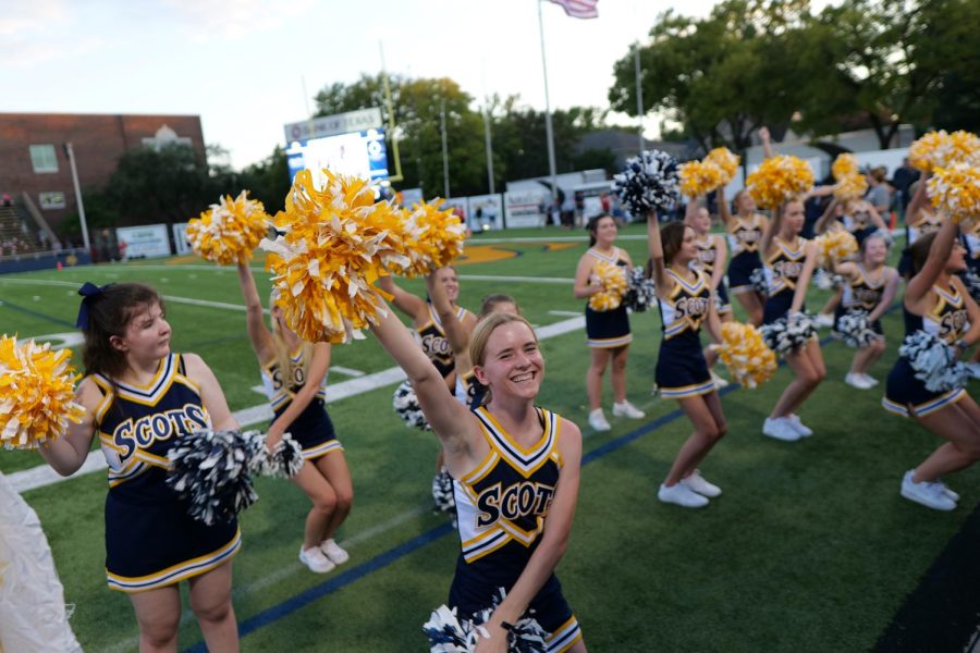 At the first home football game, senior Julia Yates cheers with the Spirited Scots cheer squad. The team went up against Marcus High School, which was their first time playing and winning as a  6A team. I felt excited to be able to cheer with my squad and its always so fun when we win, Yates said. 