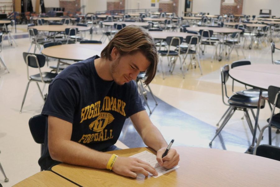 Senior Ryan Yates fills out a voter registration card during lunch. He plans to vote in the Nov. 8 midterms. Voting is important because it gives everybody a voice and a chance to speak up about their opinions, he said.