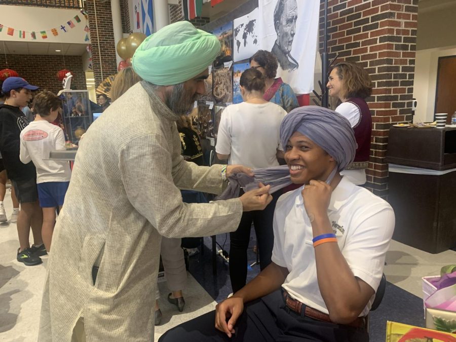 Parent+Sandeep+Singh+wraps+a+turban+around+senior+Carter+Morelands+head.+Singhs+stand+at+culture+fest+showcased+Indian+culture+as+well+as+Sikhism.+%5BShowcasing+culture%5D+takes+the+stigma+away%2C+when+people+understand+Indians+and+Sikhism+people+get+along+better%2C+Singh+said.+