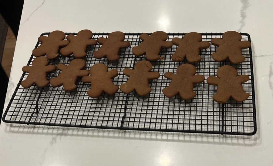 The gingerbread cookies when theyre out of the oven and cooling. They can be iced and decorated to add to the festive feeling.