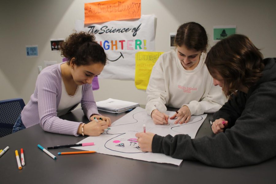 Freshmen Suri Sakhai, Olivia Bond and Lila Biffle collaborate on a project in biology class. After online learning ended, collaborative learning returned to normal. "Group projects are fun, and I am happy to be together with friends in person instead of in breakout rooms," Sakhai said. 