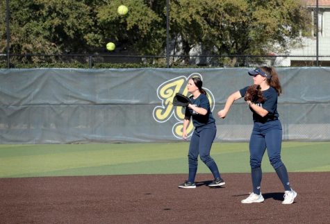 During practice, senior Taylor Stanford and junior Audrey Schedler work on pitching and catching.  This the first year the team will play for 6A. I think theres potential for a solid year as long as we keep working to build team chemistry, Schedler said.  