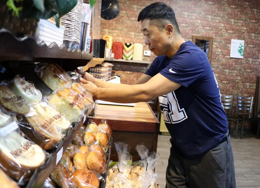 The New York Bakery owner Sang-min Lee restocks products before opening the store for the day. Lee moved to Los Angeles from South Korea and hopes to expand his business as well as bring attention to other flourishing Korean businesses in the area. I want to expand the [bakery]. Many Korean bakeries appear every and its good [for the community], Lee said. 
