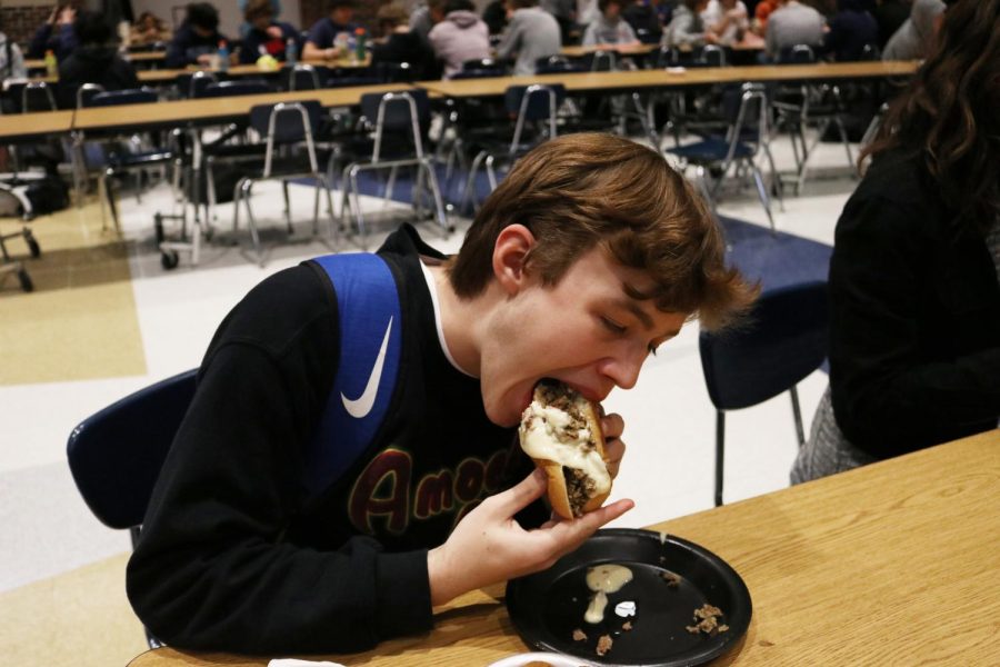 In the cafeteria sophomore Graham Longhofer eats a cheese burger. Cheese burgers take about 660 gallons of water to produce according to the University of London. "I Like that beef can be eaten in many different ways and that it comes from cows," he said. 