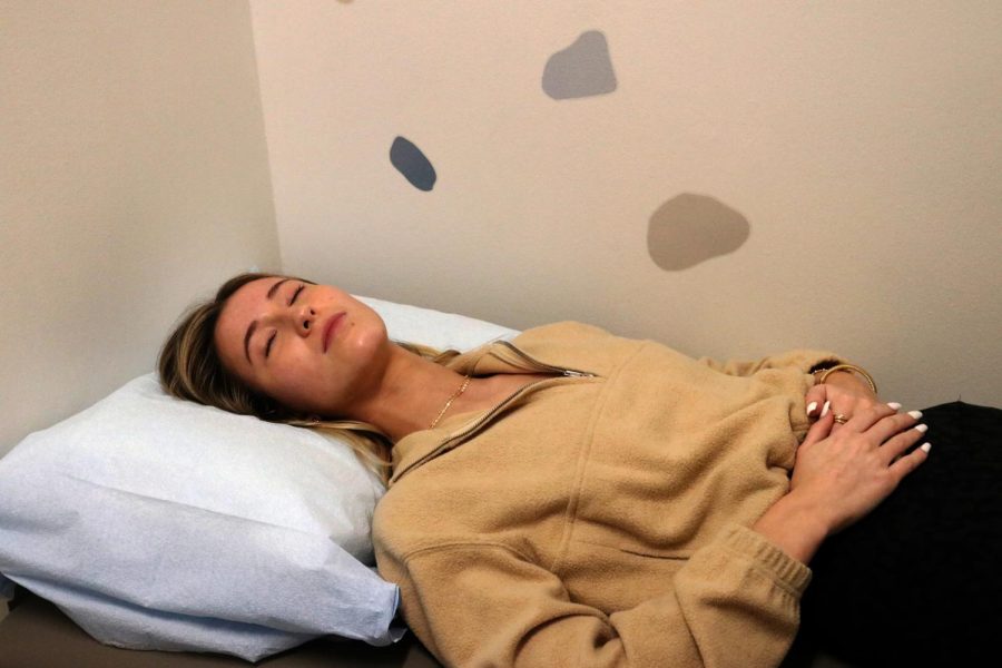 During passing period, junior Peggy Ferguson lies down in the nurses office. She often experiences period cramps that she says can feel debilitating and has noticed that people, men in particular, are not always understanding. Men act like women are acting dramatic when it comes to pain, but they havent even experienced it, Ferguson said. 