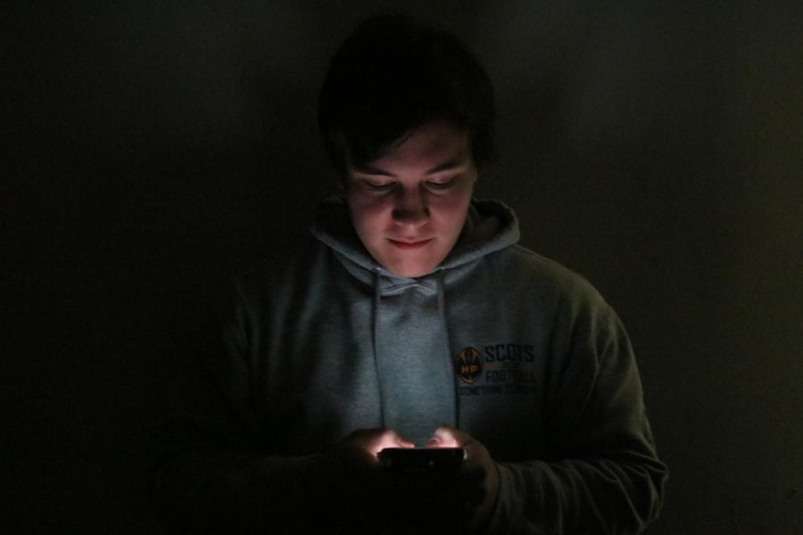 Senior Ben Salter scrolls on his phone in between classes. Salter says even though he knows being on his phone for long periods of time is unhealthy, its hard to let go of the habit of grabbing his phone the moment he feels bored. Im not productive because of my phone usage and I feel like Ive missed out on a lot of experiences happening around me, Salter said. 