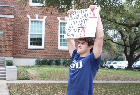 Senior Tommy Rossley holds up a sign in favor of protecting gun rights. The second amendment is something Rossley values and believes should be protected. I love to hunt and believe that our right to bear arms should be protected, he said. 