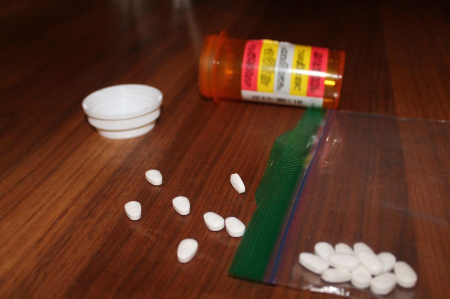 Prescription pills are strewn across a table. Along with other powerful drugs, fentanyl is becoming an increasingly dangerous substance among young adults.