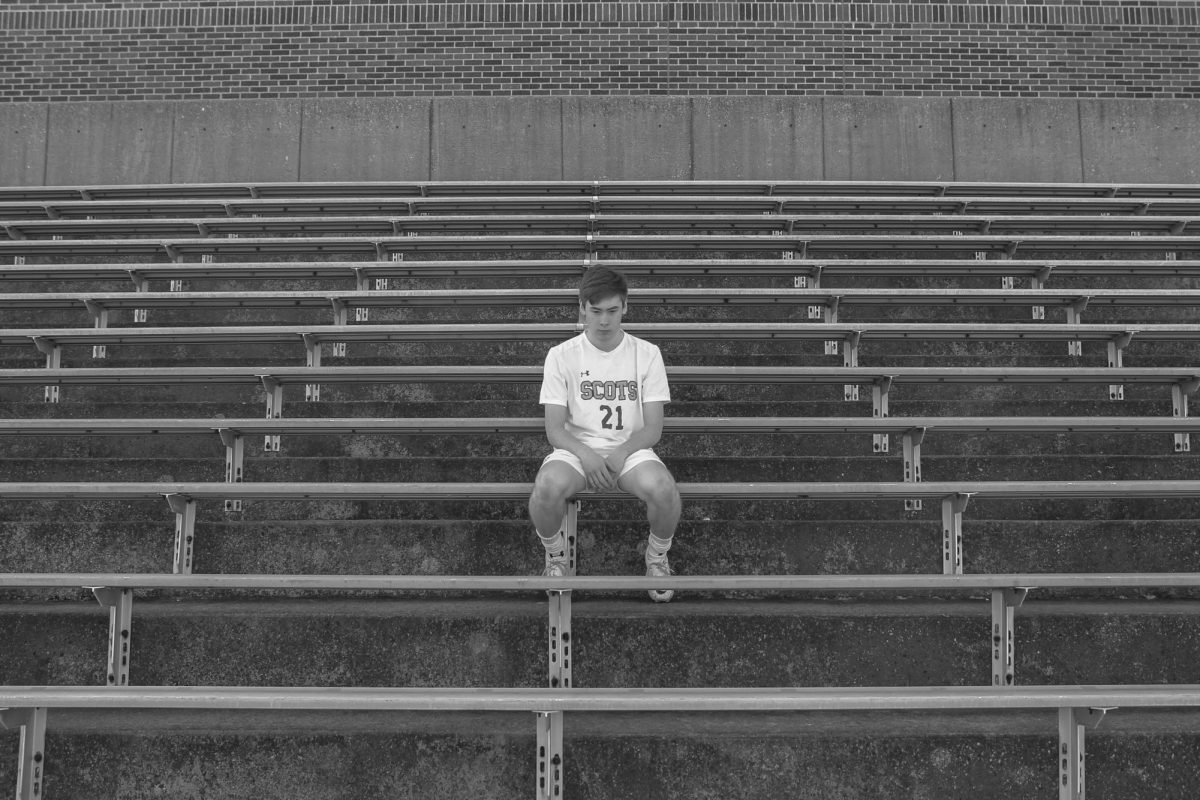 Soccer captain Paul Michael Healy poses dejectedly on the empty stadium stands. 