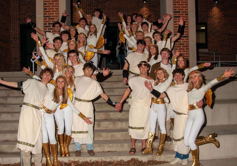 Hilites Club poses in their group costume, gods and goddesses, outside of the school. Club members have worked tirelessly to organize all aspects of the dance. Weve grown so close together and now were so comfortable around each other,” social upstairs Amelia Bollman said. We have the best time and thats honestly why I joined.