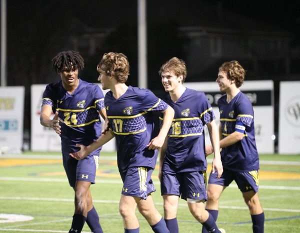 Teamates Obi Nwosu, Colin Kamhi, Brant Williams and Ryan Beck celebrate after Kamhi scores a goal. We had a slow start but once we found the rhythm with the game we scored a ton of goals and it was great, Kamhi said. 