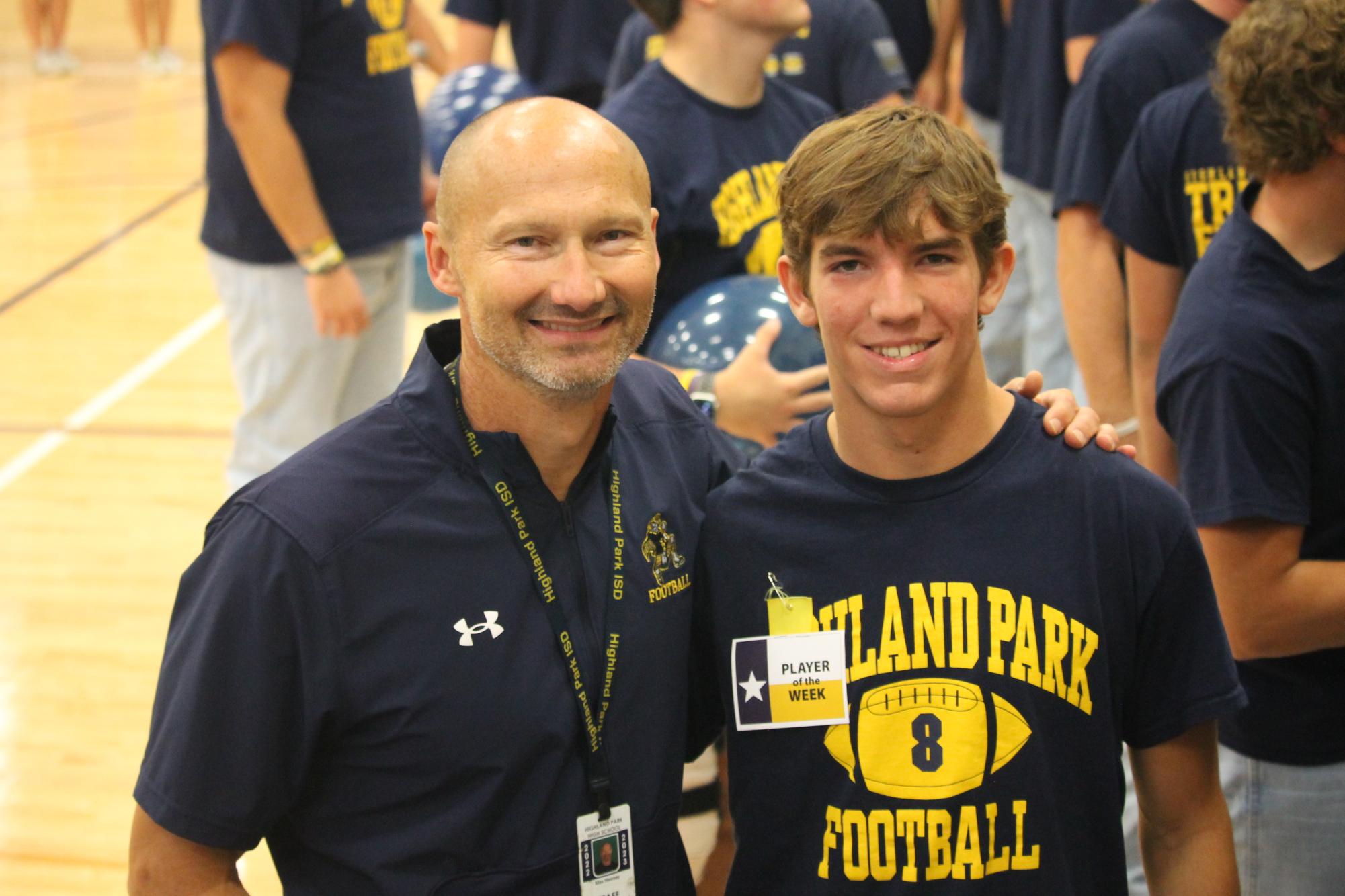 Sophomore Buck Randall stands with football coach Max Hawsey after winning "Player of the Week" award.